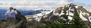 Female hiker looking at snow covered peaks