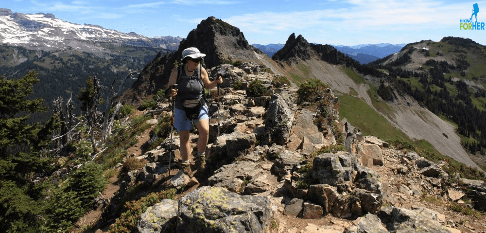 Female hiker with trekking poles on rocky Plummer Peak, Mount Rainier National Park Female hiker with trekking poles on rocky Plummer Peak, Mount Rainier National Park