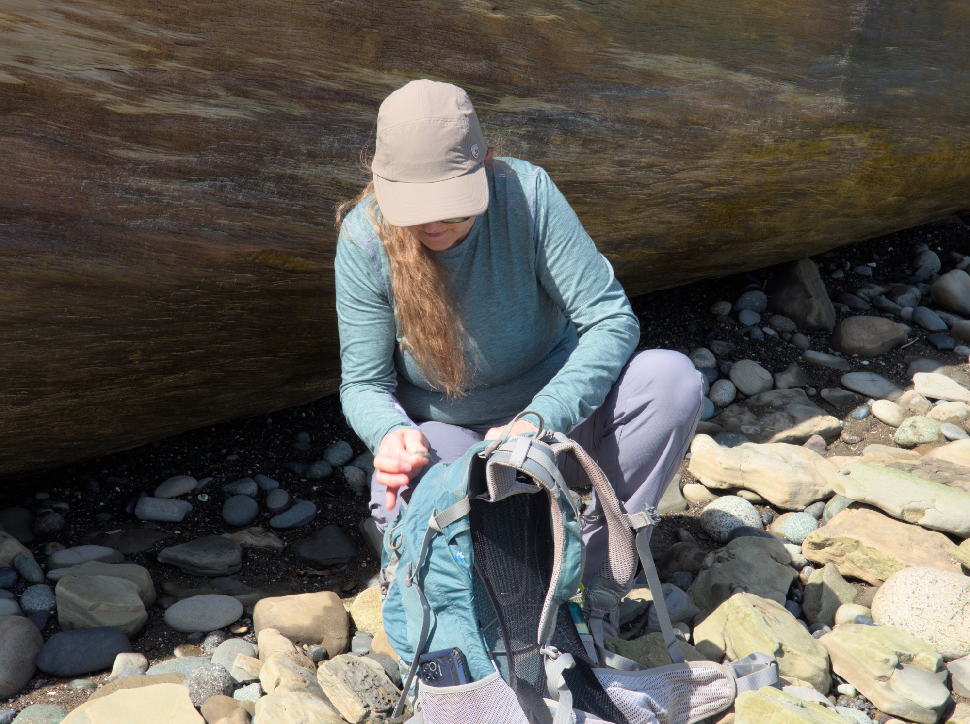 Female hiker reaching into backpack