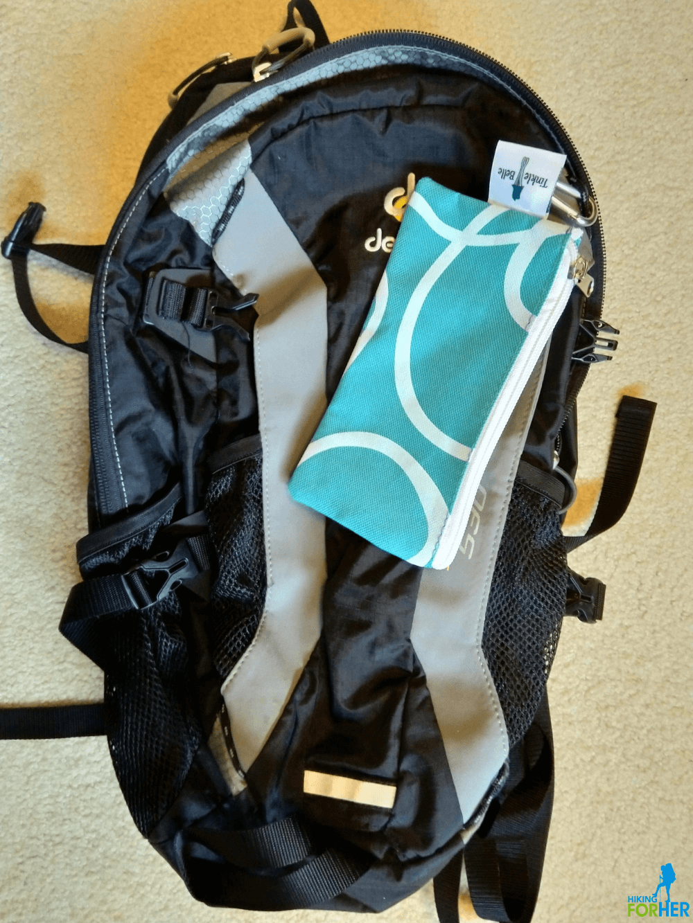 TinkleBelle carrying case clipped to hiking daypack with a small carabiner TinkleBelle carrying case clipped to hiking daypack with a small carabiner