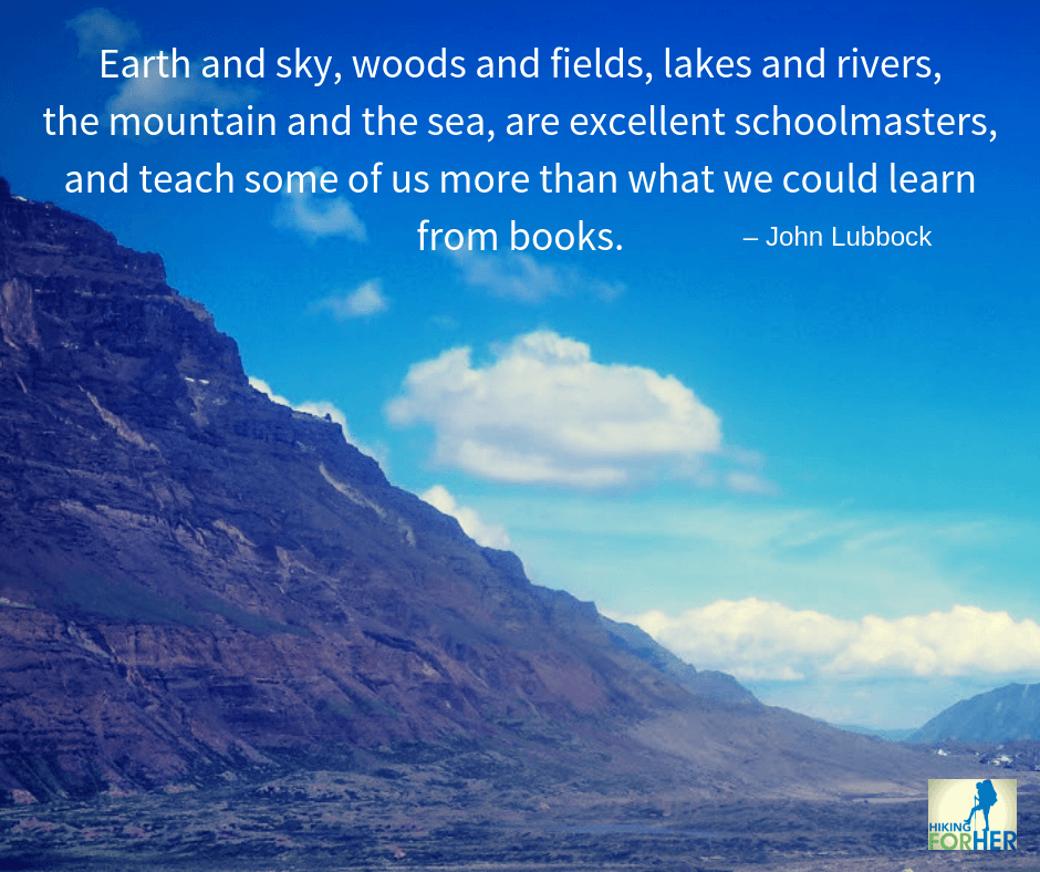 Wide blue sky, puffy white clouds, towering mountains