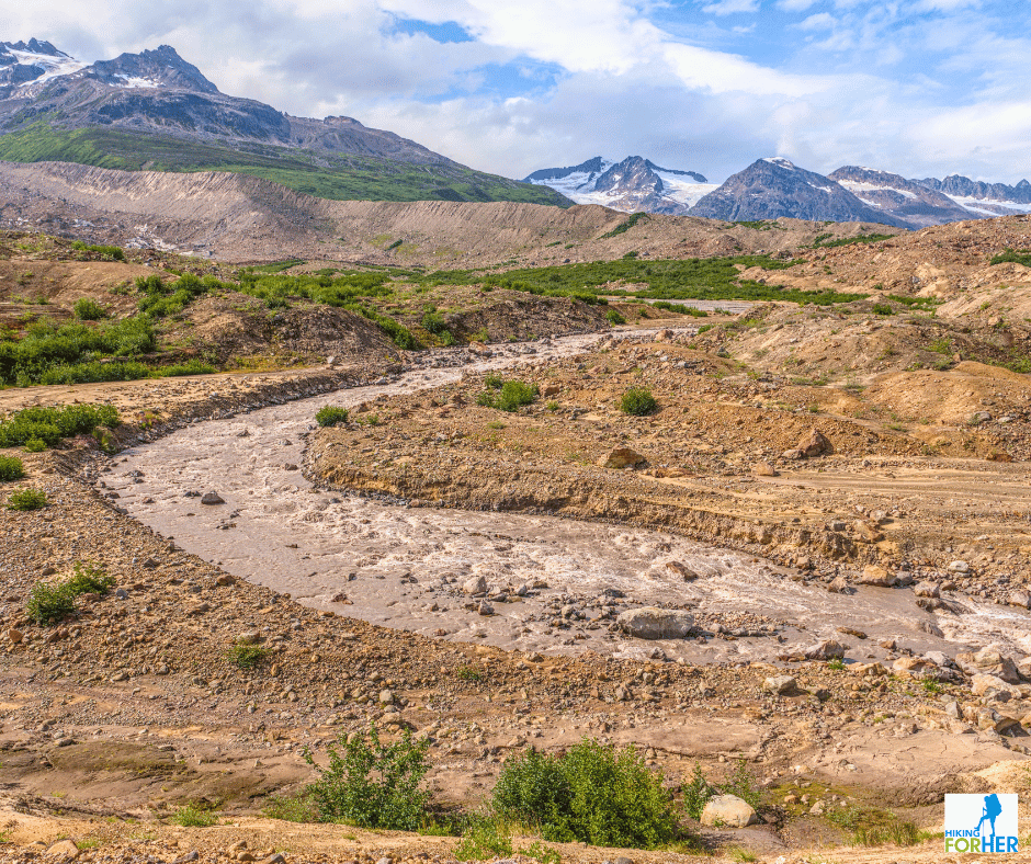 Silty chocolate milk looking river flowing off glacier in Alaska with peaks in background Silty chocolate milk looking river flowing off glacier in Alaska with peaks in background