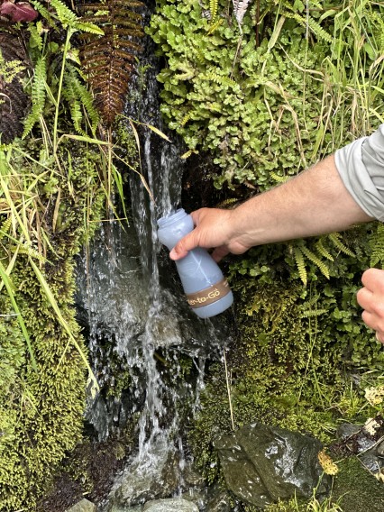 Water-to-Go filtration bottle being filled in a flowing stream while hiking Water-to-Go filtration bottle being filled in a flowing stream while hiking