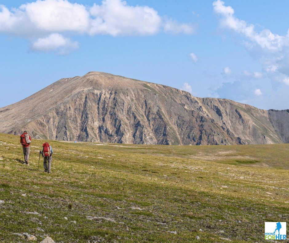 Two hikers crossing alpine tundra in Alaska