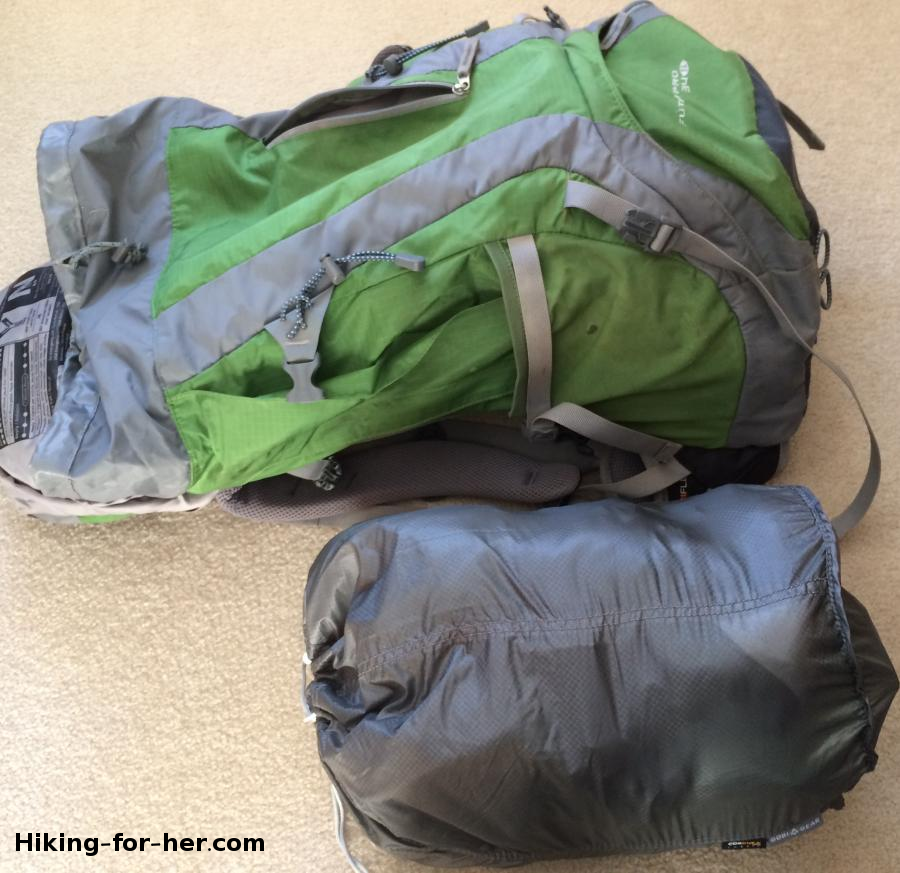 Green hiking backpack lying next to a GobiGear segmented stuff sack for size comparison Green hiking backpack lying next to a GobiGear segmented stuff sack for size comparison