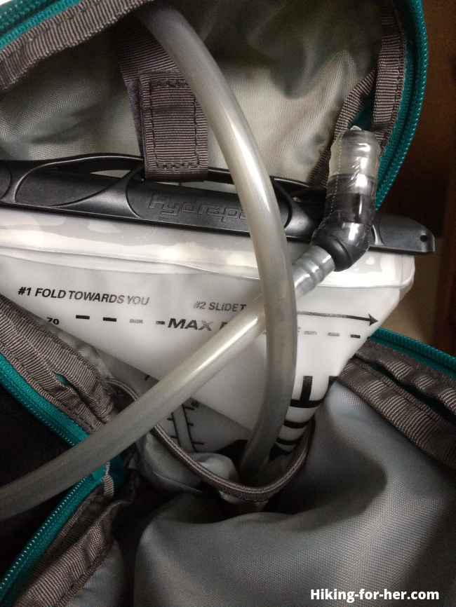 Hiking hydration bladder outlet