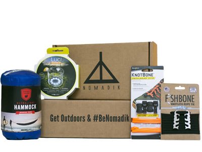 The Nomadik subscription box with logo and examples of outdoor gear The Nomadik subscription box with logo and examples of outdoor gear